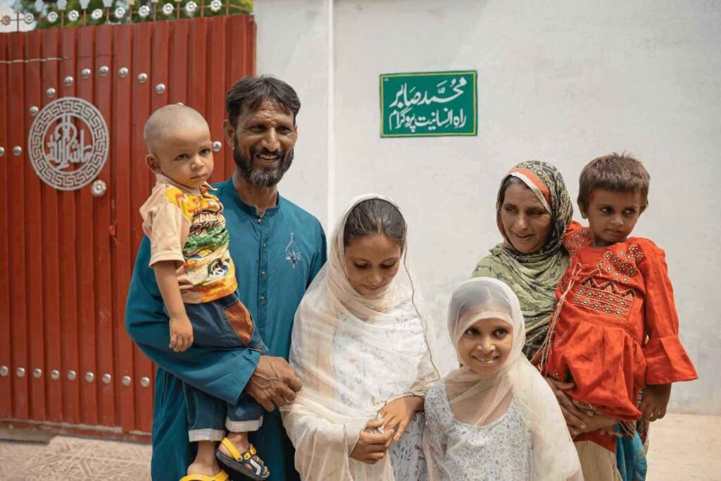 Family standing outside their new home